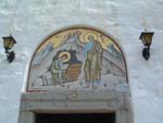 Stained glass picture of St John and his scribe writing Revelations